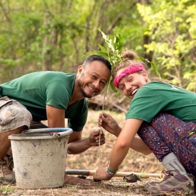 A Projects Abroad staff member and a student plant trees as part of their conservation volunteer work in Costa Rica. A volunteer and staff member work together on a reforestation initiative during Conservation volunteering in Costa Rica.